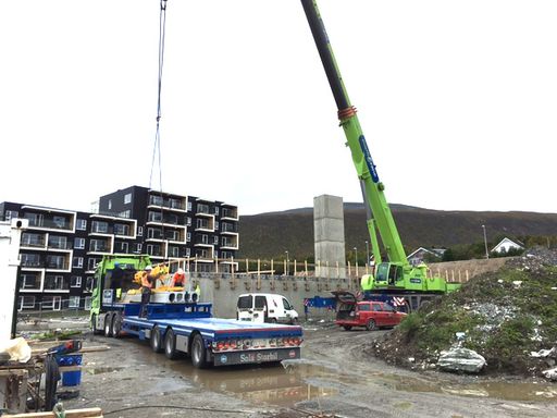 Kranbil plukker materiale fra lastebil